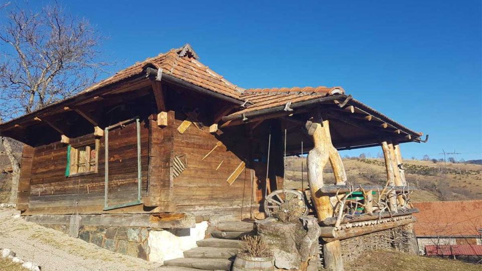 Traditional wooden rural house with a porch and a view of nature